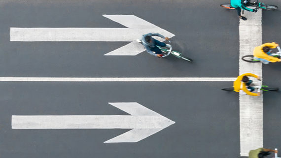Birds-eye view of a road with cyclists.