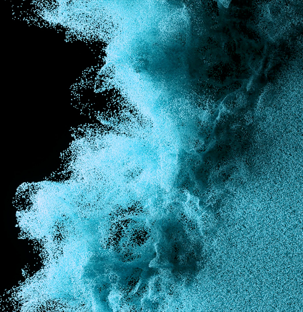 Wind blowing blue particles on a black surface